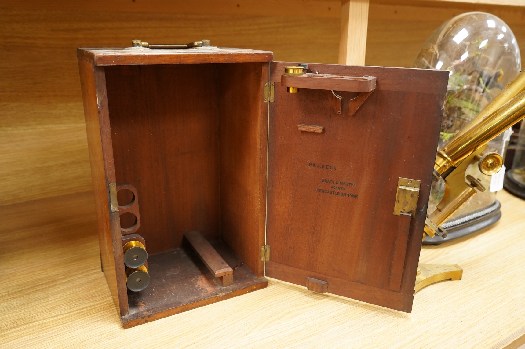 A late 19th century brass compound binocular microscope, by R. & J. Beck, London, number 13654, mahogany cased, together with accessories, including a pair of eye pieces and three objectives. Instrument height 39cm